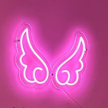 Load image into Gallery viewer, pink-neon-angel-wings-sign-wall-mounted-on-a-glowing-pink-background
